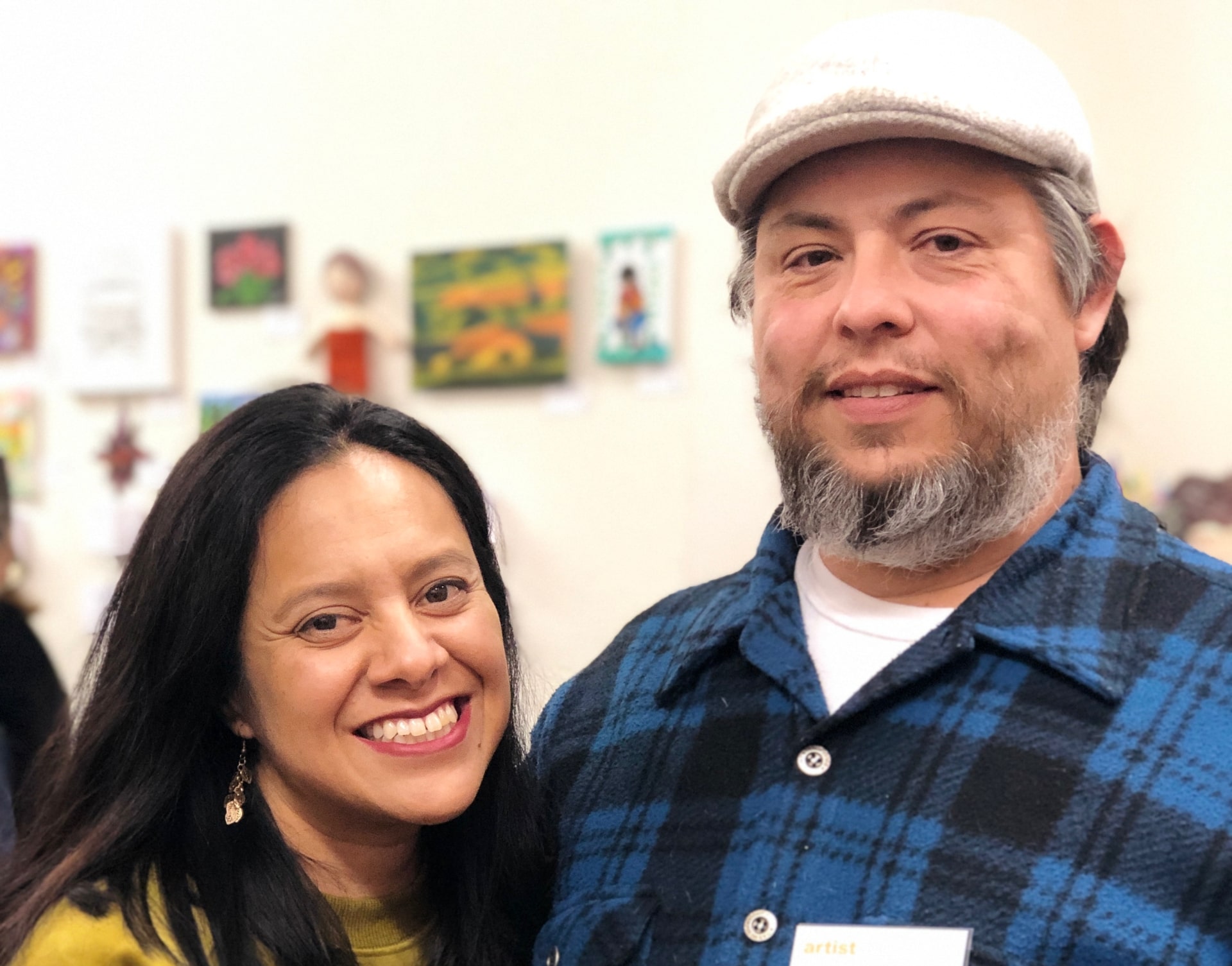 Woman and man Arts Council members smiling and posing for photograph