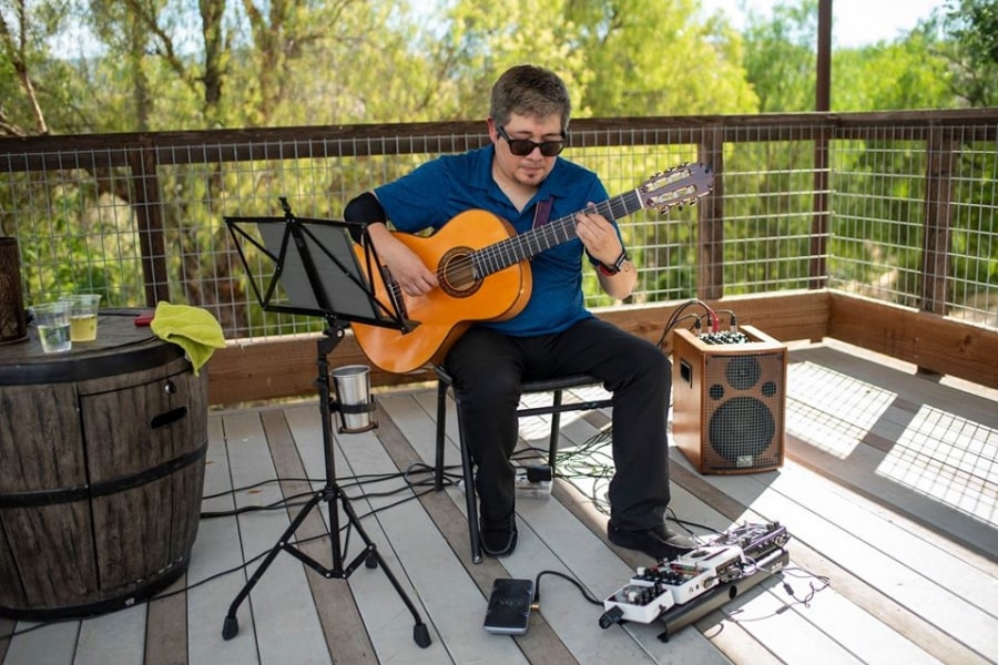 Guitarist sitting on porch playing music